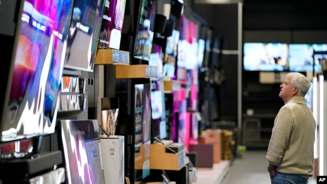 FILE - A customer browses televisions at a Best Buy store in Charlotte, North Carolina, Nov. 24, 2023.