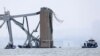 Emergency boats work near the collapsed section of the Francis Scott Key Bridge, after the Dali cargo vessel crashed into it, in Baltimore, March 27, 2024. 