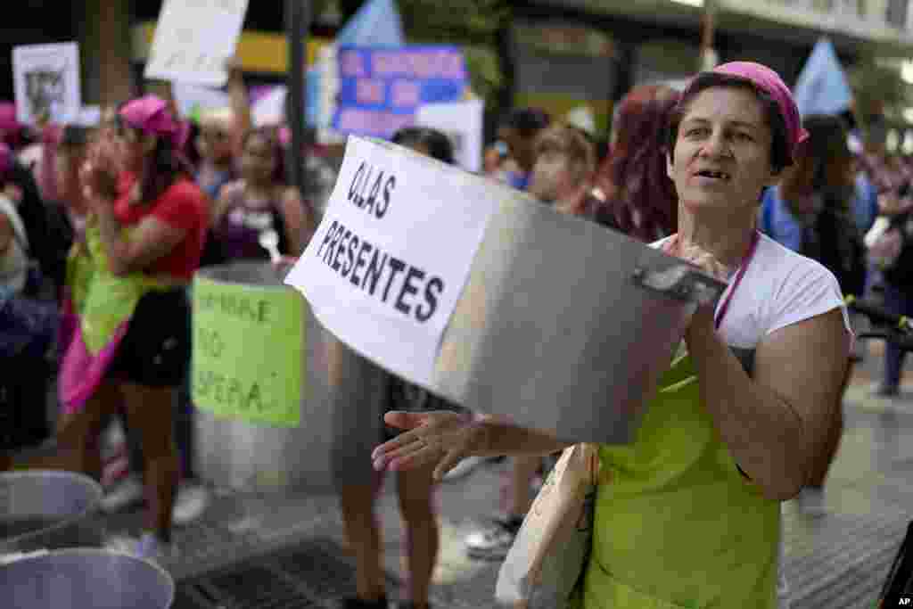 Women from social movements hold empty pots outside the hotel where Argentine President Javier Milei has been residing since winning the election to demonstrate against food scarcity at community soup kitchens in Buenos Aires.