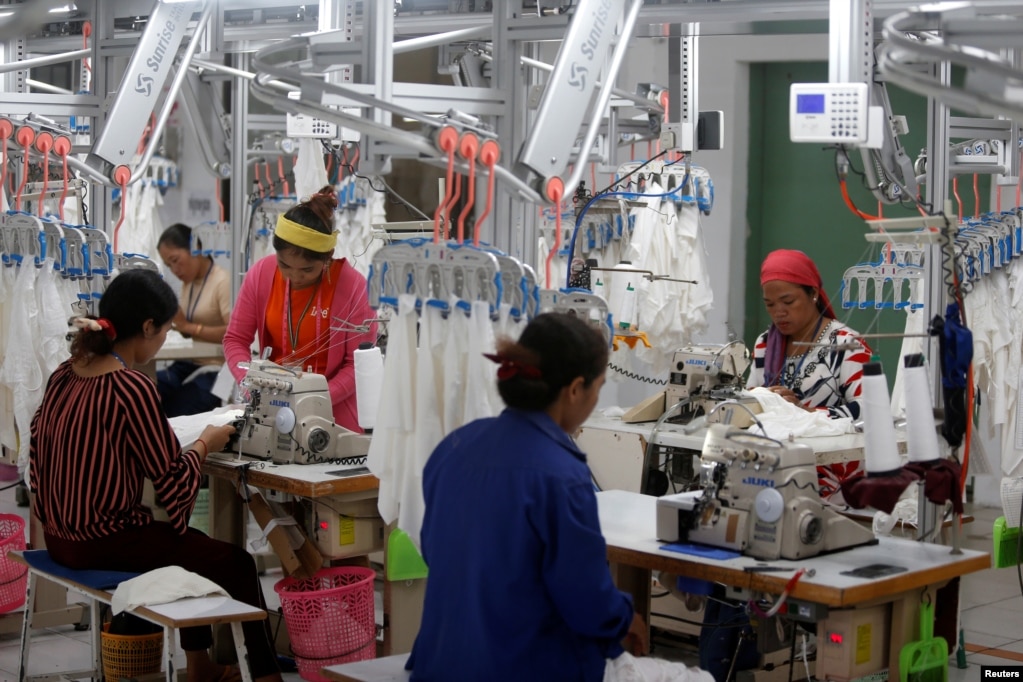 FILE - Employees work at a factory supplier of the H&M brand in Kandal province, Cambodia, December 12, 2018.