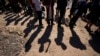 FILE — Migrants wait to be processed after crossing the Rio Grande and entering the United States, Oct. 19, 2023, in Eagle Pass, Texas. Lawmakers are trying to agree on measures to curb the influx of migrants at the US-Mexico border. 