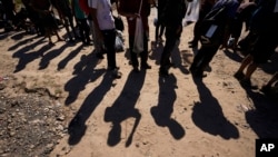 FILE - Migrants wait to be processed by the U.S. Customs and Border Patrol after they crossed the Rio Grande and entered the U.S. from Mexico, Oct. 19, 2023, in Eagle Pass, Texas.