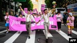 FILE - People attend a Pride event in support of LGBTQ rights, during the Seoul Queer Culture Festival, in Seoul, South Korea on July 1, 2023.