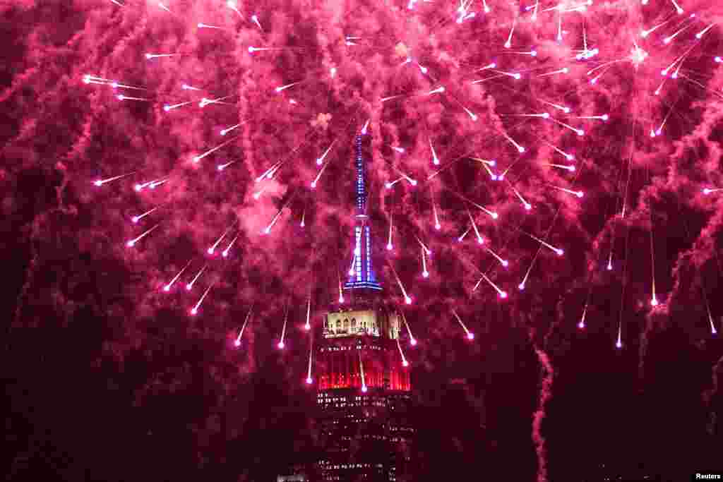 The Macy's 4th of July Firework Show are seen over the Empire State Buiulding as it is seen from Hoboken, New Jersey, July 4, 2024.