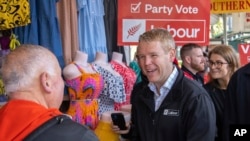 New Zealand's Prime Minister Chris Hipkins meets people on the street in Auckland on Oct. 13, 2023, the last day of campaigning for New Zealand's election. 
