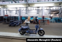 A worker pushes a scooter at the Caribbean Electric Vehicles (VEDCA) factory in Havana, Cuba, July 15, 2024. (REUTERS/Alexandre Meneghini)