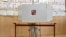 A woman prepares her ballots for the European Parliament elections at a polling station in Prague, Czech Republic, June 7, 2024.