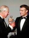 French President Emmanuel Macron, right, and Britain's King Charles III toast during a state dinner in the Hall of Mirrors at the Chateau de Versailles in Versailles, west of Paris, Sept. 20, 2023. 