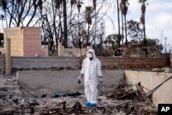 Rev. Ai Hironaka, resident minister of the Lahaina Hongwanji Mission, stands in the grounds of his temple destroyed by wildfire, Dec. 7, 2023, in Lahaina, Hawaii.