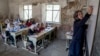 FILE - A teacher leads a class of girls on the first day of the school year, in Kabul, Afghanistan, March 25, 2023. Taliban bans in the country prohibit access to education for girls age 12 and older. 