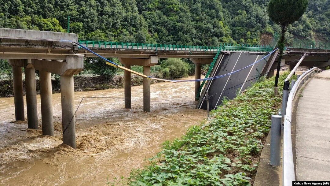In this photo released by Xinhua News Agency, a collapsed bridge is seen in Zhashui County in Shangluo City, northwest China's Shaanxi Province, July 20, 2024. (Xinhua News Agency via AP)