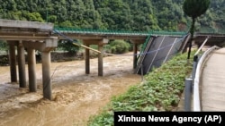 In this photo released by Xinhua News Agency, a collapsed bridge is seen in Zhashui County in Shangluo City, northwest China's Shaanxi Province, July 20, 2024. (Xinhua News Agency via AP)
