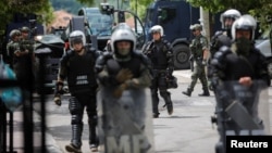 Polish Kosovo Force (KFOR) soldiers stand guard at a municipal office in Zvecan, Kosovo, May 30, 2023.