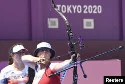 FILE - Naomi Folkard of Britain competes in archery during the Tokyo Olympic on July 25, 2021. Folkard competed five months after giving birth to a daughter.