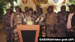 This video grab shows the spokesperson for the mutinous soldiers speaking on state television as they announce that they had seized power in Libreville, Gabon, Aug. 30, 2023. (GABON 24 via AP)