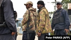 Polisi bersenjata Papua Nugini bersiap untuk berpatroli sebagai ilustrasi. Seorang profesor universitas Australia termasuk di antara kelompok yang disandera di dataran tinggi Papua Nugini. (Foto: AFP/Peter PARKS)