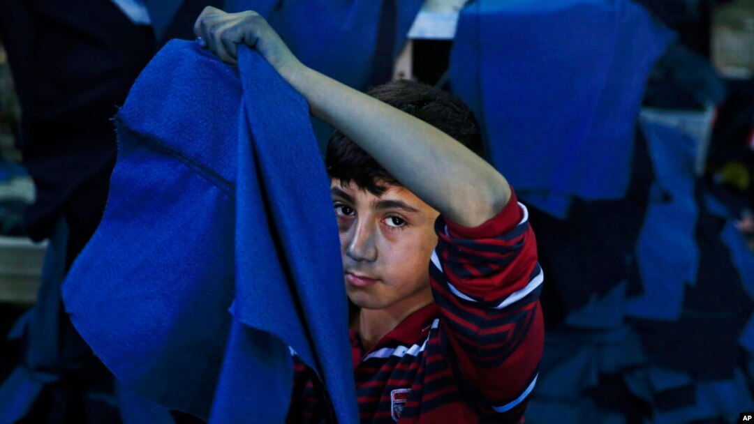 FILE - Mohammed, a Syrian refugee child, works at a clothing workshop in Gaziantep, Turkey, June 2, 2016. A recent report on child labor in Turkey said at least 695 child workers had died in the country in the past 11 years.