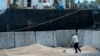 FILE - Workers load grain at a grain port in Izmail, Ukraine, April 26, 2023. 