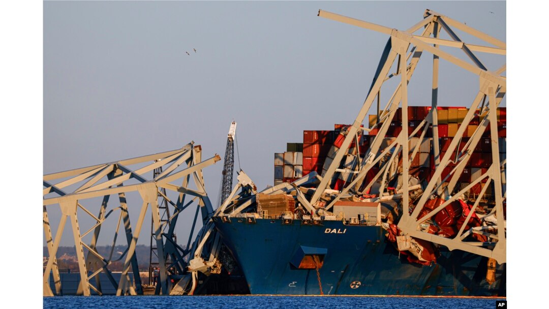 Cranes stand by the wreckage of the Francis Scott Key Bridge in Baltimore, Maryland, March 30, 2024.