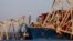 Cranes stand by as the wreckage of the Francis Scott Key Bridge rests on the container ship Dali in Baltimore, Maryland, March 30, 2024, in Baltimore.
