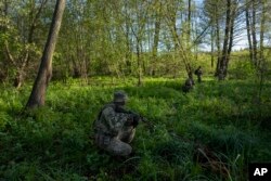 A Ukrainian Border Guard soldier participates in a military exercise in central Ukraine, May 2, 2023.