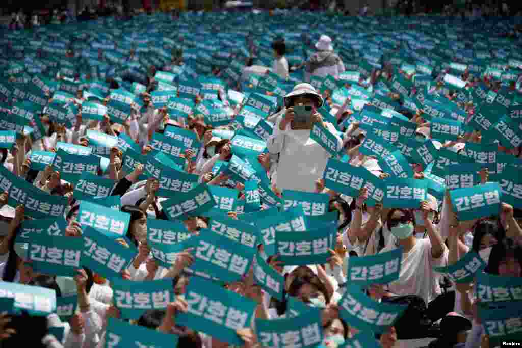 Nurses and university students majoring in nursing hold up signs that read "Nurse act," during a protest against President Yoon Suk Yeol vetoing a nursing act that defines the roles and responsibilities of nurses, in Seoul, South Korea.