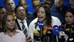 Opposition leader María Corina Machado speaks to reporters regarding the arrest order for her campaign manager and eight other opposition members for alleged involvement in a plot to destabilize the government, in Caracas, Venezuela, March 20, 2024.