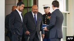 FILE - Former NFL player Jim Brown, center, steps out of the West Wing to speak on the presidential pardon of Edward DeBartolo Jr. at the White House in Washington on Feb. 18, 2020. Brown, a Pro Football Hall of Famer, actor and activist, died May 18, 2023.