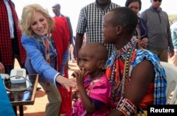 FILE - US first lady Jill Biden, meets a traditional Maasai woman and her child at a nutrition outpost at the Lositeti village in Matapato North, Kajiado County, Kenya February 26, 2023.