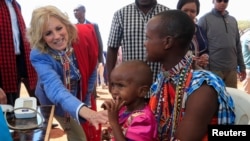 US first lady Jill Biden, meets a traditional Maasai woman and her child at a nutrition outpost within the drought response site, to highlight the impacts of drought relief at the Lositeti village in Matapato North, Kajiado County, Kenya Feb. 26, 2023. 