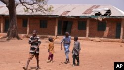 FILE — Children walk past classrooms at the LEA Primary and Secondary School Kuriga where students were kidnapped in Kuriga, Kaduna, Nigeria, March 9, 2024.