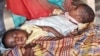 FILE - The twin babies of Sudanese refugee Fatma Ibrahim — who fled the violence in the city of Nyala, South Darfur — get treated for severe malnourishment at a Kalma IDP camp health center in South Darfur, Sudan, Feb. 18, 2024. 