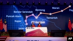 China's Premier Li Qiang, left and Malaysian Prime Minister Anwar Ibrahim attend an event for East Coast Rail Link, in Rawang, outskirts of Kuala Lumpur, Malaysia, June 19, 2024, in this photo released by Malaysia's Prime Minister office.
