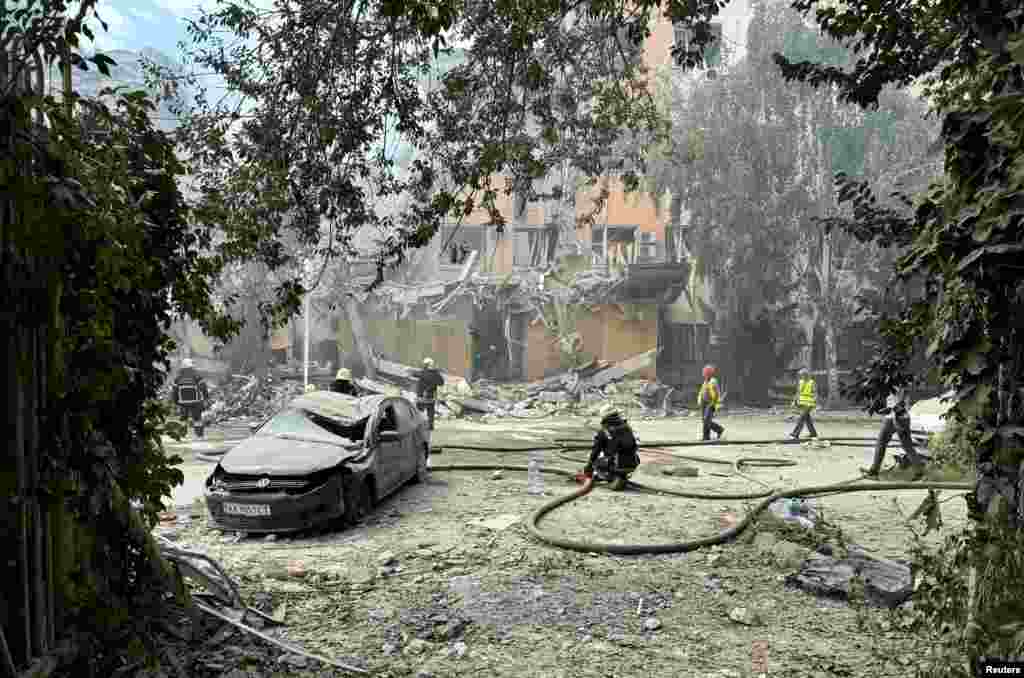 Rescuers work at the site of a Russian missile strike in Kharkiv, Ukraine.