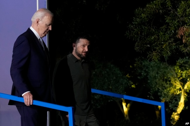 U.S. President Joe Biden, left, and Ukraine's President Volodymyr Zelenskyy leave after they signed a bilateral security agreement during the sidelines of the G7 summit at Savelletri, Italy, June 13, 2024.