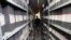 An employee walks between shelves at the archives department of the Tele Liban network in Beirut, Lebanon, Dec. 29, 2023.