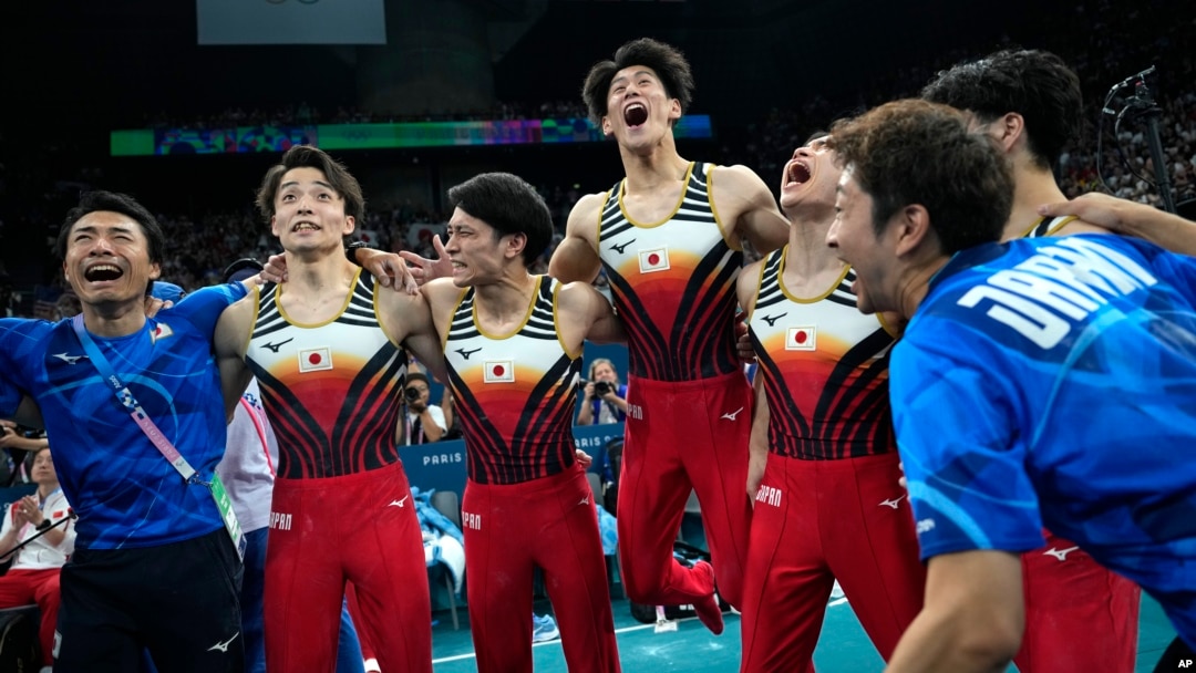 Members of Team Japan celebrate after winning the gold medal during the men's artistic gymnastics team finals round at Bercy Arena at the 2024 Summer Olympics, July 29, 2024, in Paris. 