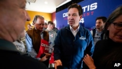 FILE - Republican presidential candidate Ron DeSantis talks with audience members, Nov. 3, 2023, in Denison, Iowa.