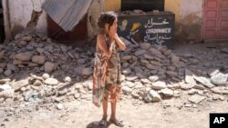 A child reacts after inspecting the damage caused by the earthquake, in her town of Amizmiz, near Marrakech, Morocco, Sept. 10, 2023. 