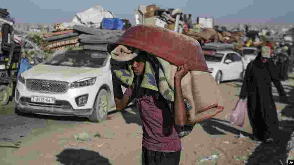 A Palestinian youth flees the Khan Younis area of the Gaza Strip, following Israeli military evacuation orders, saying its forces will soon operate there, Aug. 8, 2024.