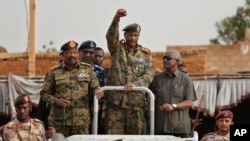 FILE - Sudanese Gen. Abdel Fattah al-Burhan, head of the military council, waves to his supporters in Omdurman district, west of Khartoum, Sudan, June 29, 2019.