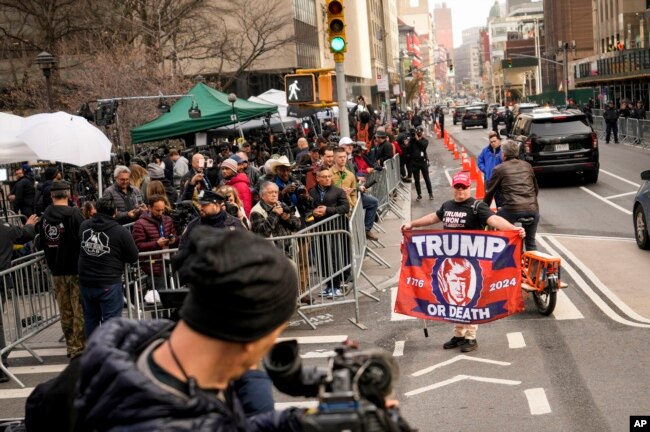 A supporter of former President Donald Trump is seen in front of assembled media and onlookers outside Manhattan Criminal Court, in New York, April 4, 2023.