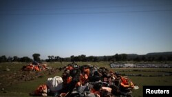 FILE - A pile of life jackets is seen on the island of Lesbos, Greece, Feb. 17, 2020. 