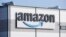 FILE - An Amazon company logo is seen on the facade of a company's building in Schoenefeld near Berlin, Germany, on March 18, 2022. Multinational companies including Amazon, Marriott and Hilton pledged June 19, 2023 to hire more than 13,000 refugees.