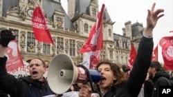 Demonstrate gather outside the Paris town hall, Friday, April 14, 2023 in Paris after France's Constitutional Council approved an unpopular plan to raise the retirement age to 64. 