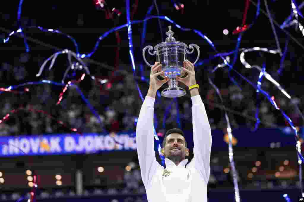 Novak Djokovic of Serbia holds up the championship trophy after defeating Daniil Medvedev of Russia in the men&#39;s singles final of the U.S. Open tennis championships, Sept. 10, 2023, in New York.