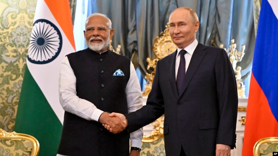 Russian President Vladimir Putin, right, and Indian Prime Minister Narendra Modi shake hands during a meeting at the Kremlin in Moscow, July 9, 2024.