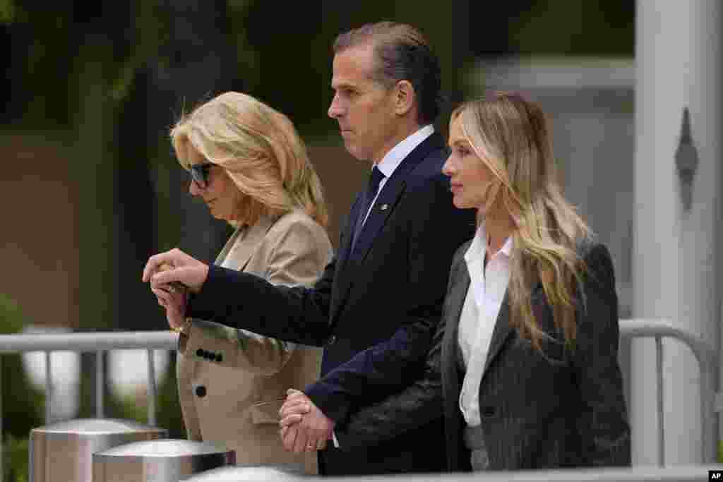 Hunter Biden, center, accompanied by his mother, first lady Jill Biden, left, and his wife, Melissa Cohen Biden, walks out of federal court after being convicted of all 3 felony charges in the federal gun trial, in Wilmington, Delaware. 