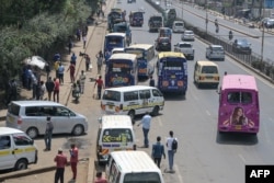 FILE - Kenyan public transport vehicles are seen picking up passengers in Nairobi, Sept. 12, 2023.