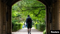 FILE - People walk on the grounds of the University of Toronto in Toronto, Ontario, Canada September 9, 2020. (REUTERS/Carlos Osorio/File Photo)